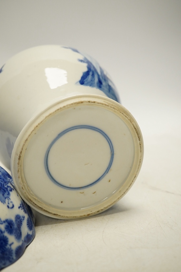 An early 20th century Chinese blue and white porcelain vase and cover decorated with figures in a landscape and a Japanese circular bowl, tallest 23cm. Condition - good